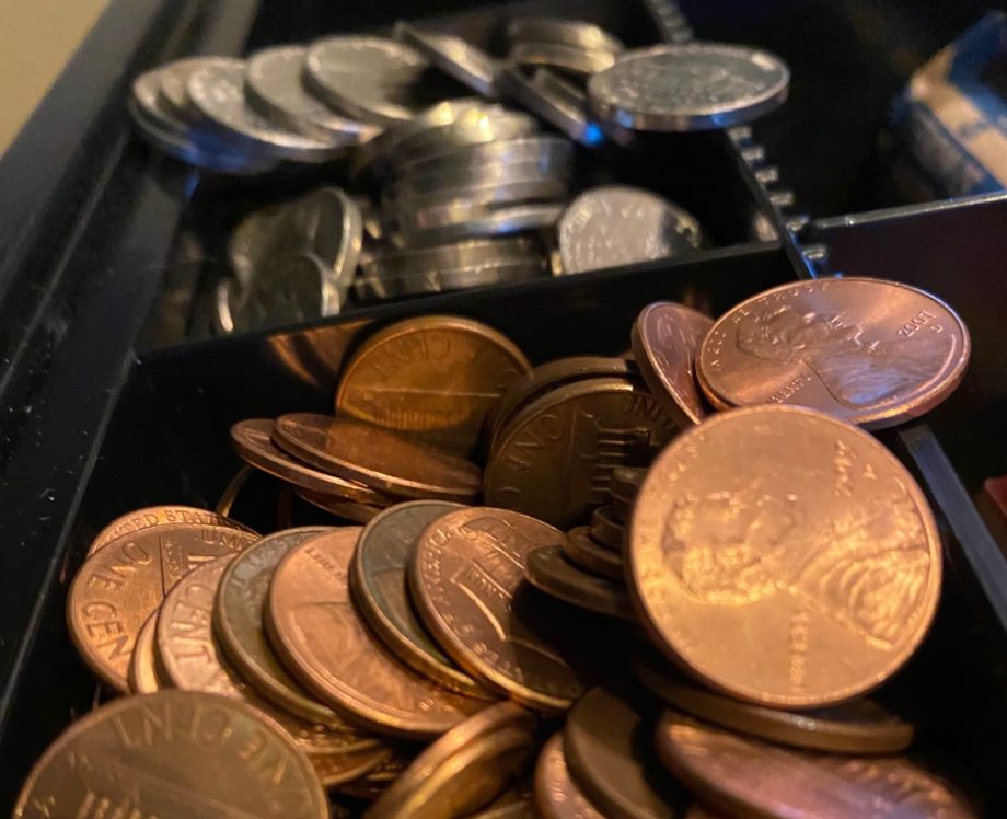 overflowing coins in cash register